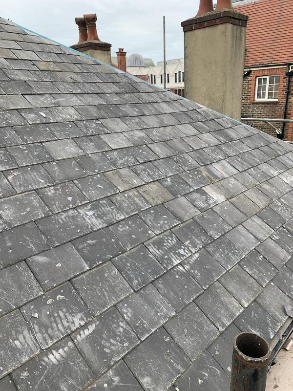 New tile roof installation in progress with breather membrane
